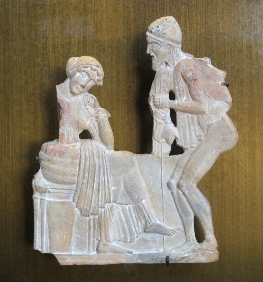 Terracotta relief: a seated woman with her head bowed on her hand, facing a bearded traveller in a conical cap who leans towards her over a staff